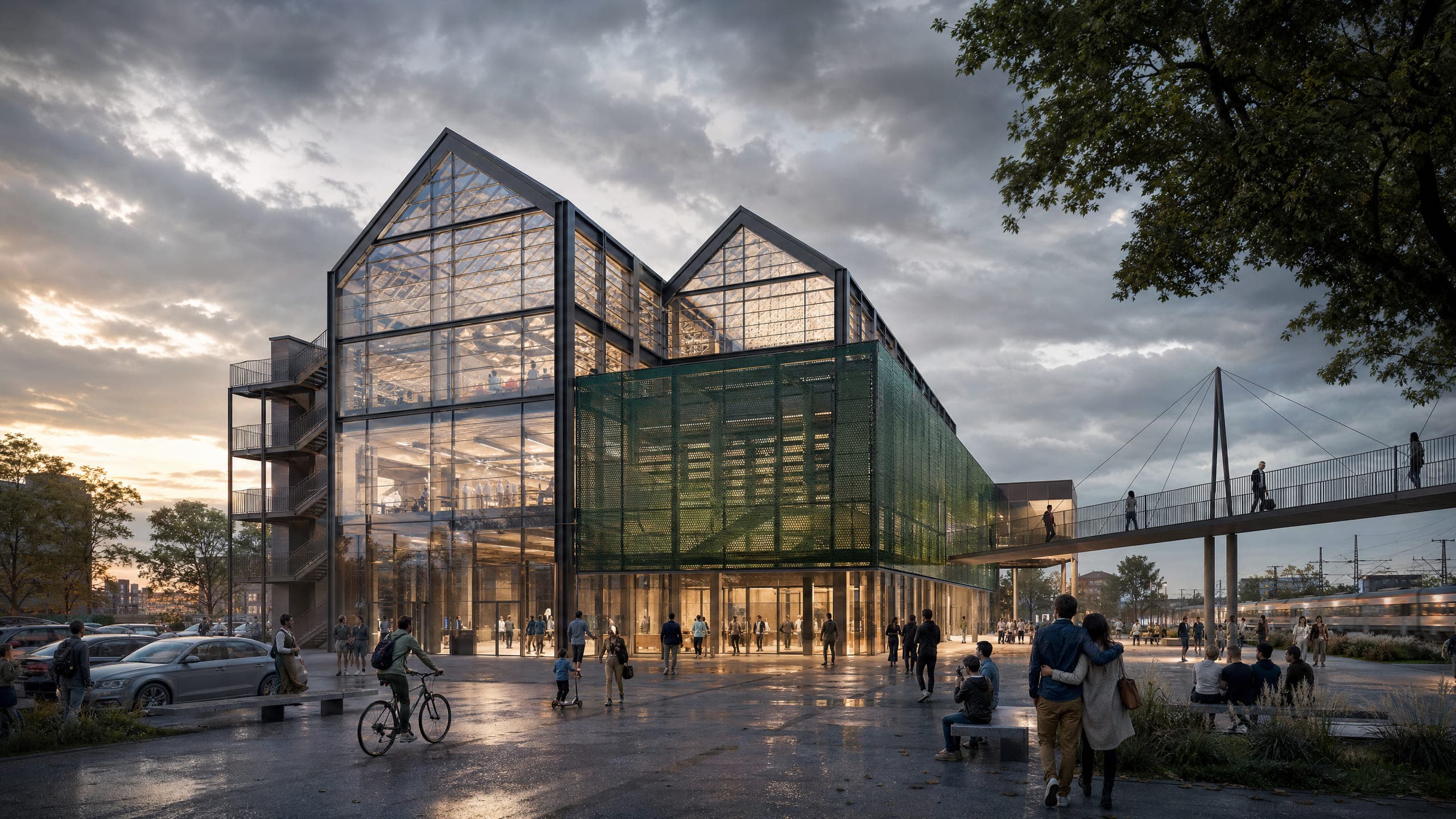 A glazed civic hall at dusk, its gabled steel frame clearly expressed